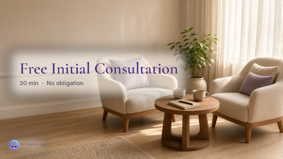 A calm consultation room at The Frequency Hub with two armchairs and tea on a wooden table